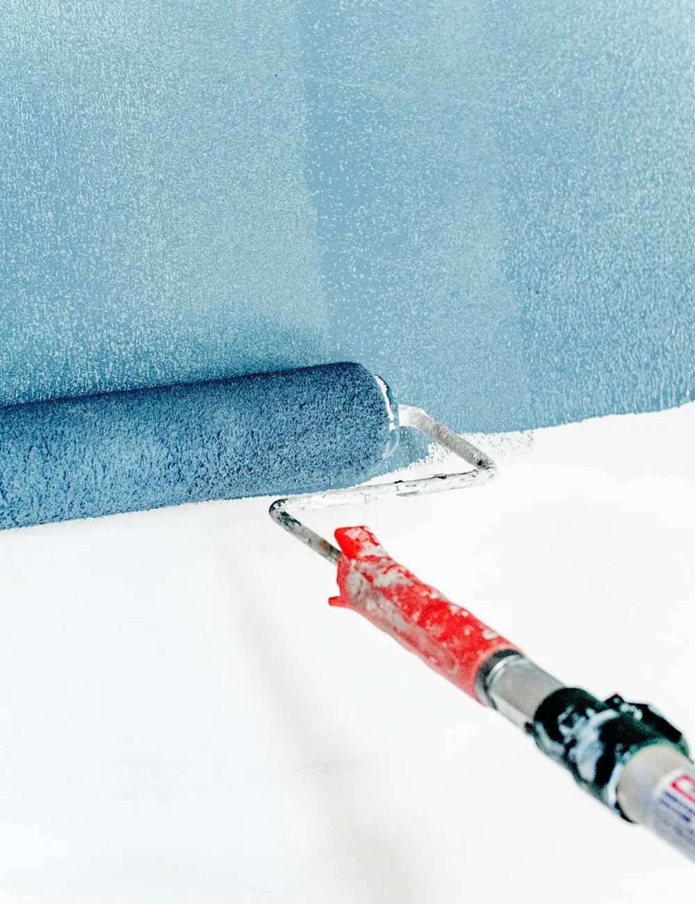 Interior wall being rolled after patch and primer